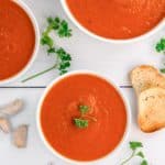 overhead view of three bowls of Instant Pot tomato soup