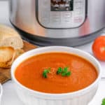 a bowl of tomato soup in front of an Instant Pot