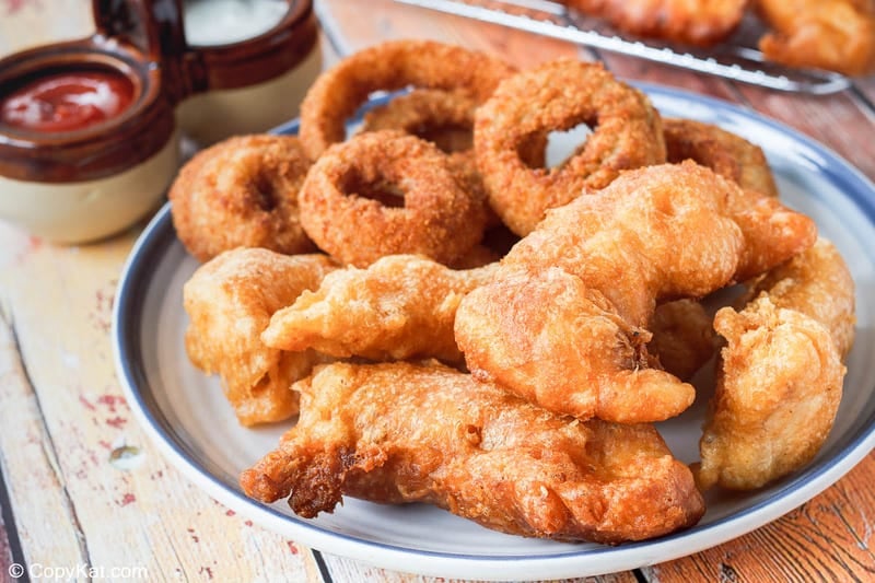 homemade Long John Silver's chicken planks and onion rings on a plate