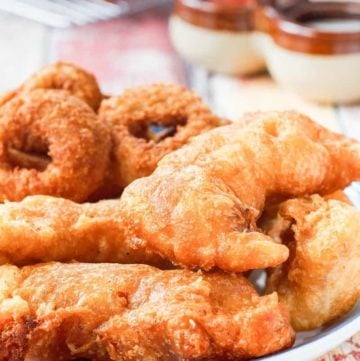 a plate of homemade Long John Silver's chicken planks and onion rings