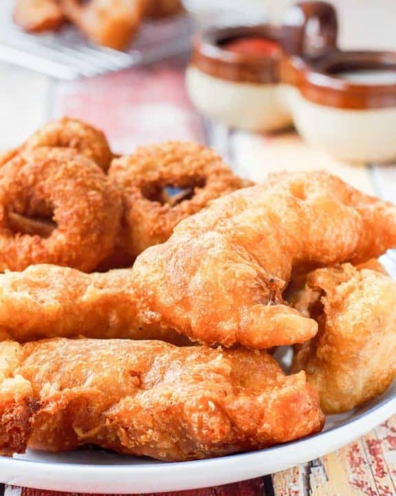 a plate of homemade Long John Silver's chicken planks and onion rings