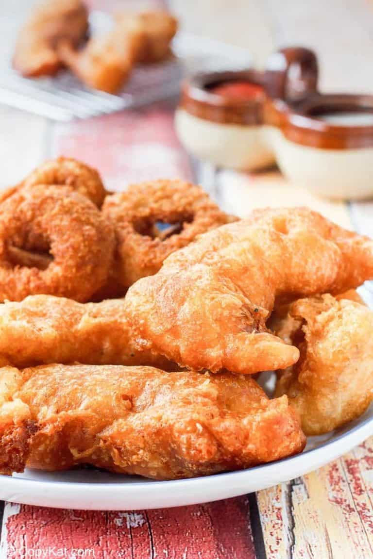 a plate of homemade Long John Silver's chicken planks and onion rings