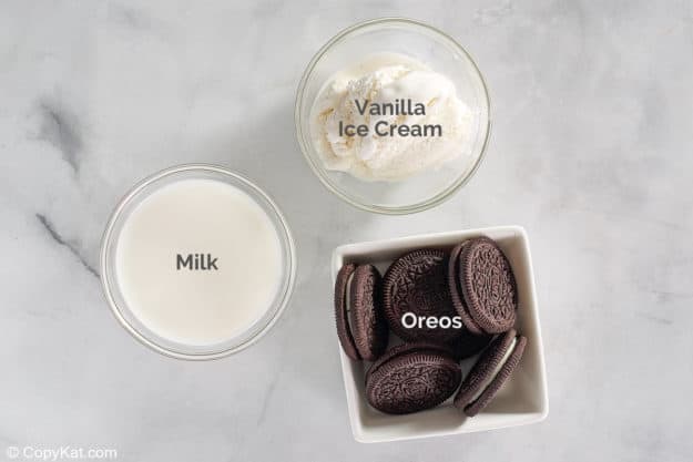 milk, vanilla ice cream, and Oreo cookies in bowls