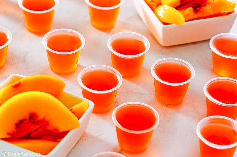 peach jello shots and two dishes of peach slices