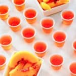 peach jello shots and two dishes of peach slices
