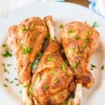 closeup photo of three roasted turkey legs on a plate