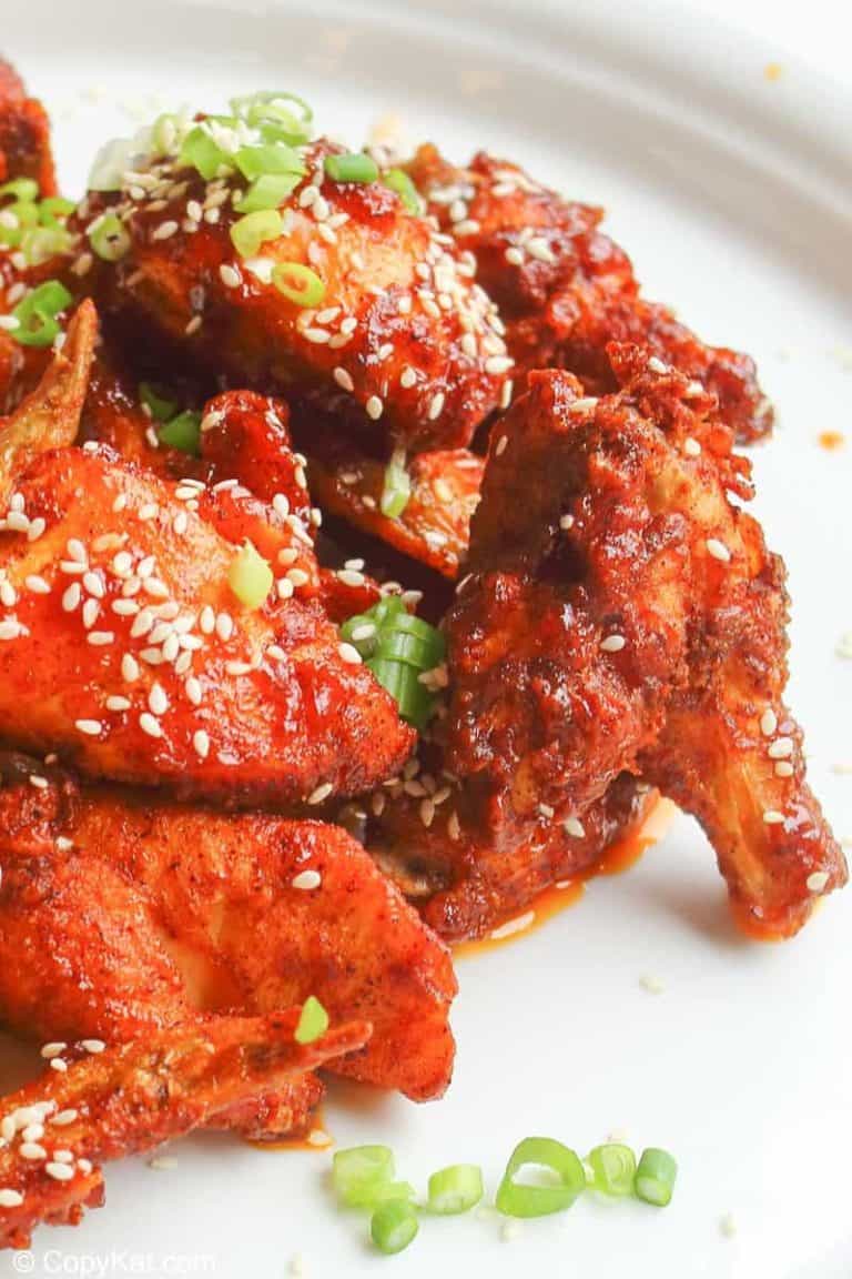 spicy chicken wings with sauce and sesame seeds on a plate