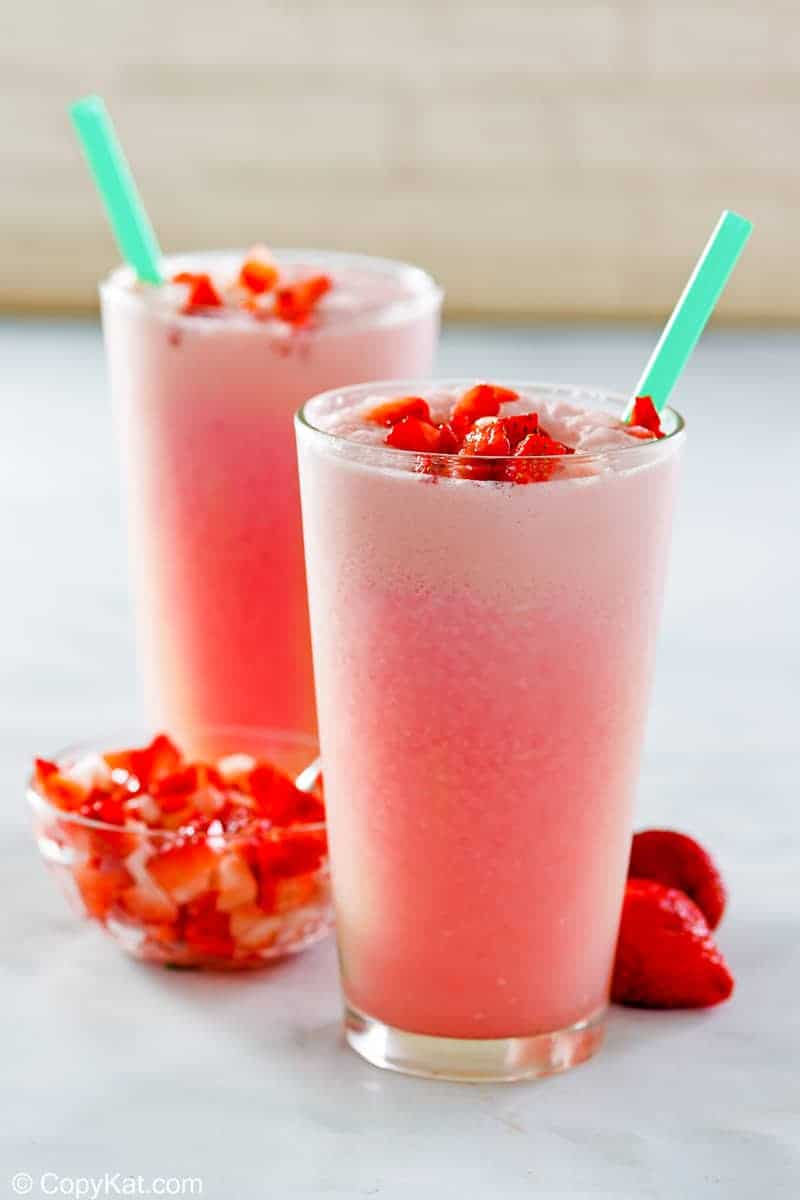 homemade Starbucks pink drink in two glasses and fresh strawberries