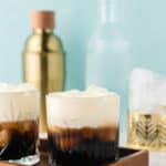 two White Russian drinks in old fashioned glasses on a serving tray