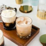 two White Russian drinks on a serving tray