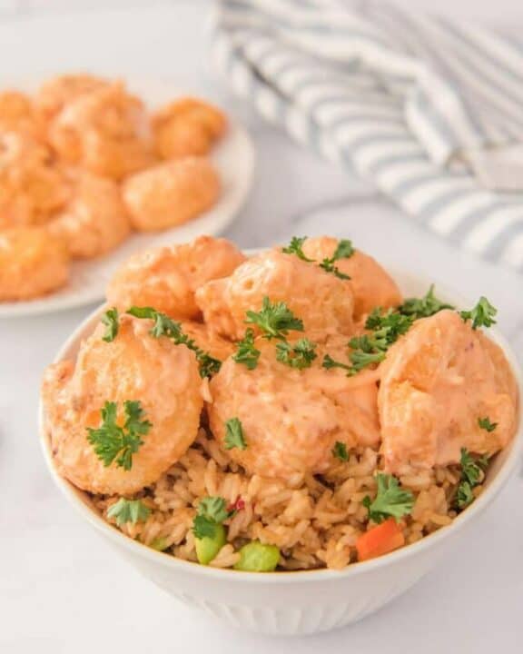 air fryer bang bang shrimp with sauce and rice in a bowl