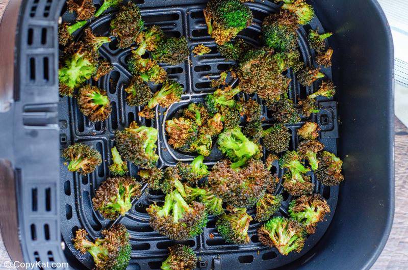 air fried broccoli in an air fryer basket