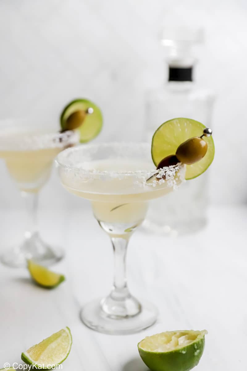 homemade Applebee's perfect margarita, fresh limes, and bottle of tequila