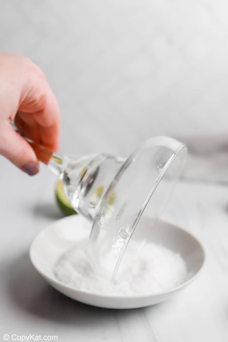 rimming a margarita glass with salt for an Applebee's Perfect Margarita