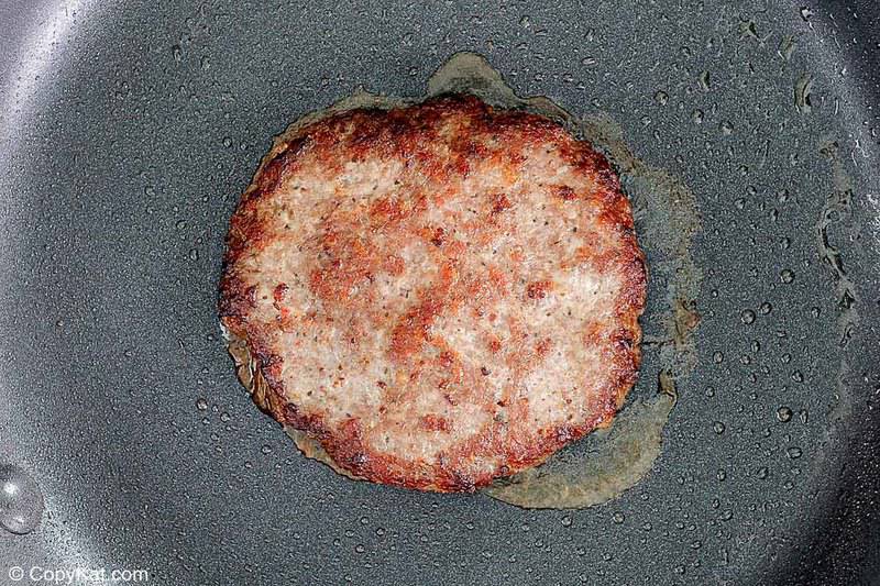 fried breakfast sausage patty in a skillet