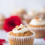 carrot cake cupcake with cream cheese frosting topped with almonds