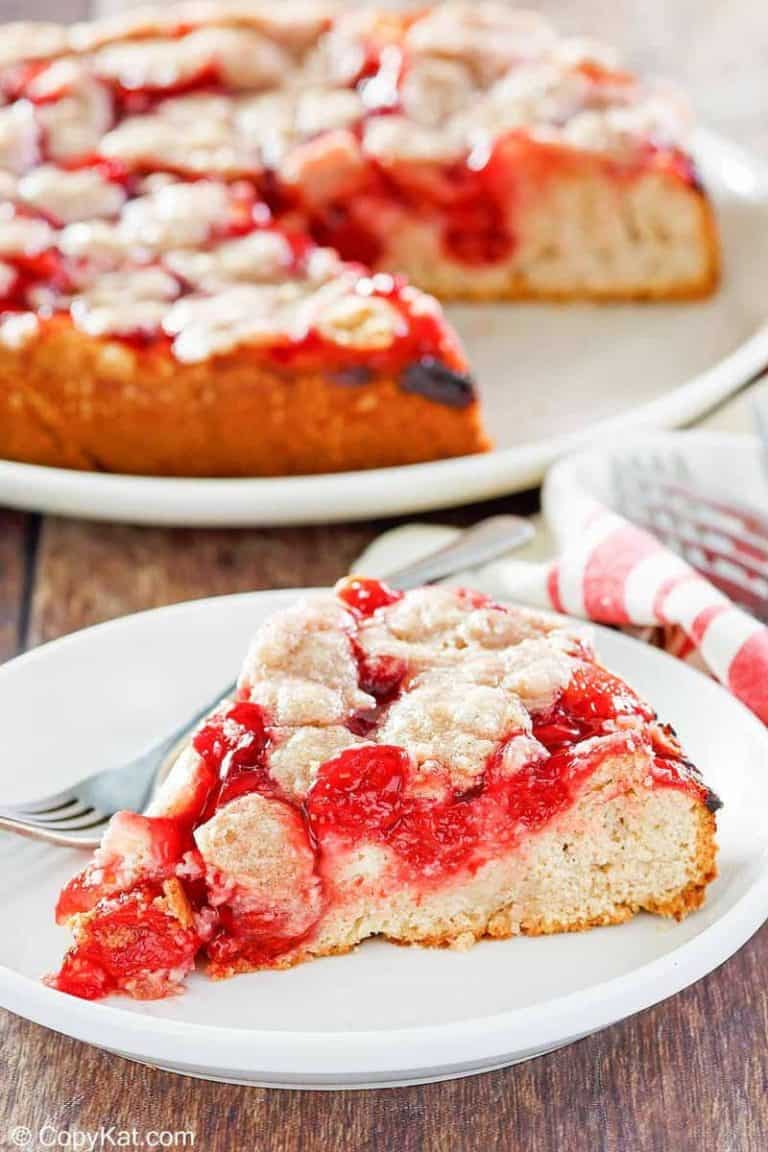 cherry coffee cake on a plate in front of the cake