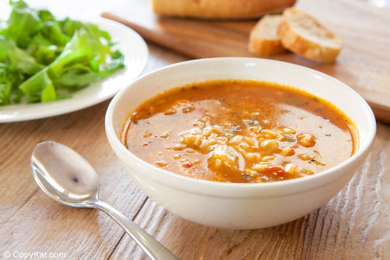 a bowl of chicken gumbo soup and a plate of salad