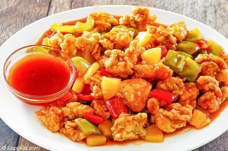 a plate of sweet and sour chicken with homemade sauce