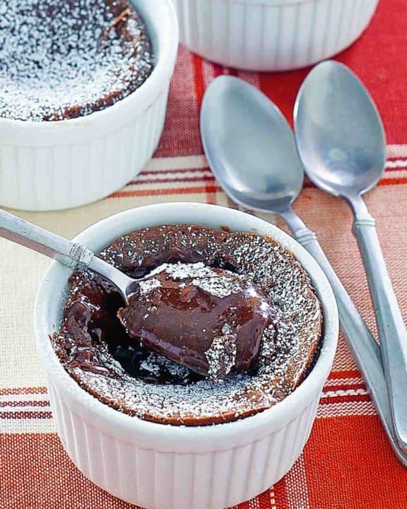 three chocolate melting cake desserts and spoons