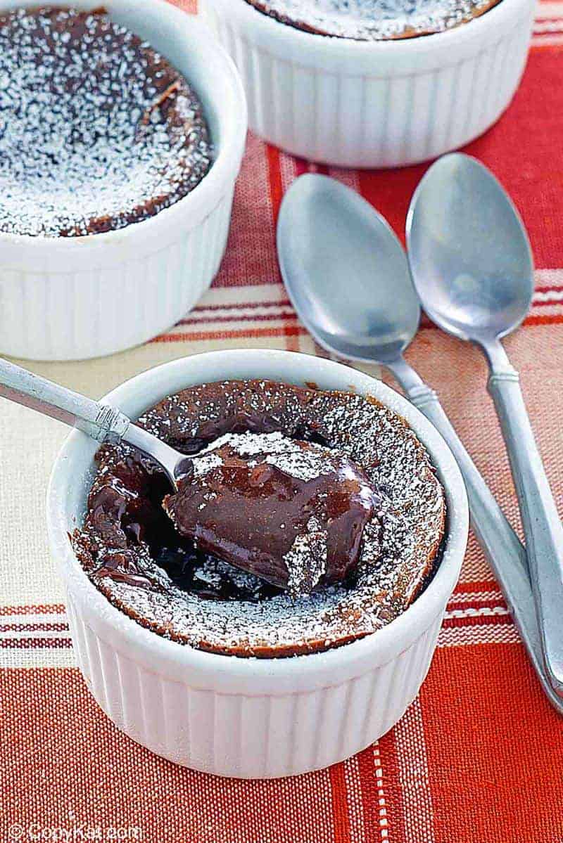 three chocolate melting cake desserts and spoons