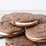 a pile of chocolate sandwich cookies on a plate