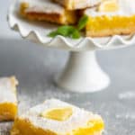 lemon bars on a table and small cake stand