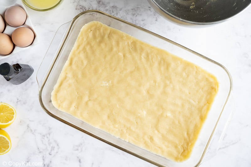 lemon bars shortbread crust dough in a baking pan
