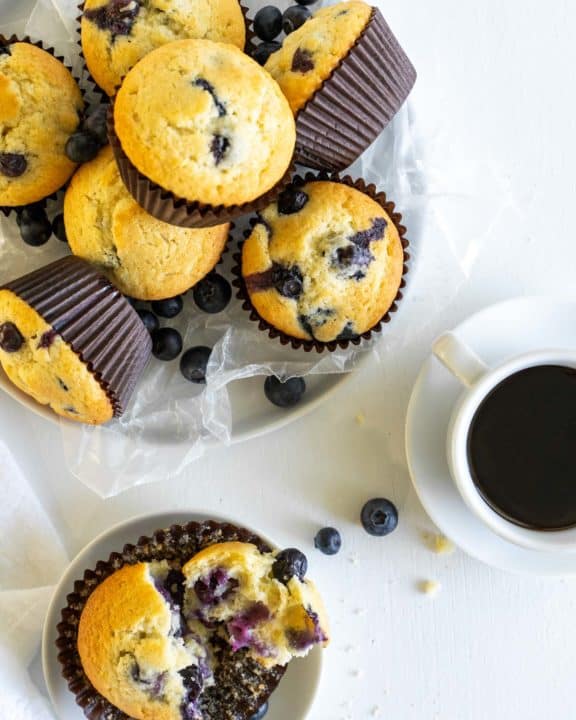 overhead view of blueberry muffins in a basket and on a plate
