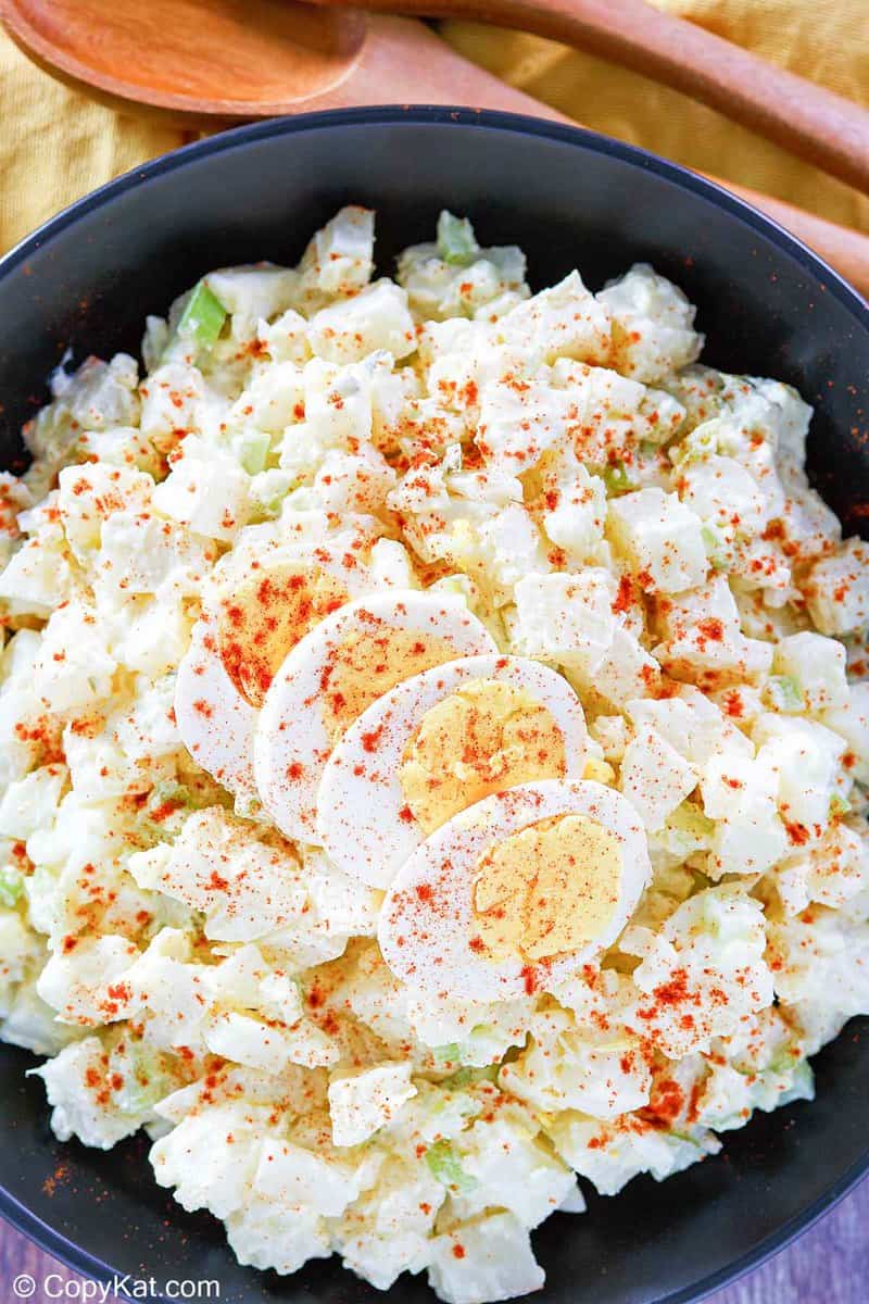potato salad topped with sliced egg and paprika