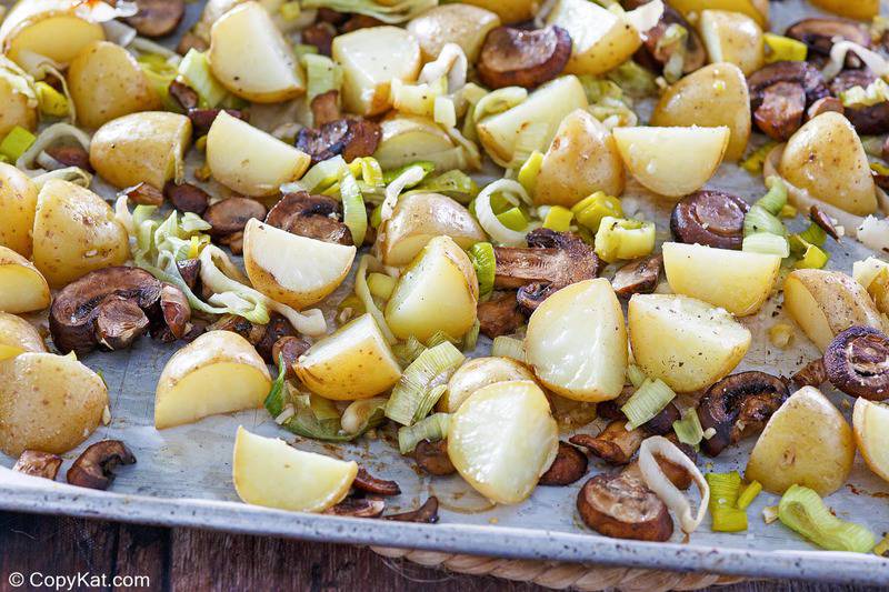 roasted leeks, potatoes, mushrooms, and garlic on a sheet pan