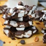 rocky road candy with walnuts stacked on a wood board