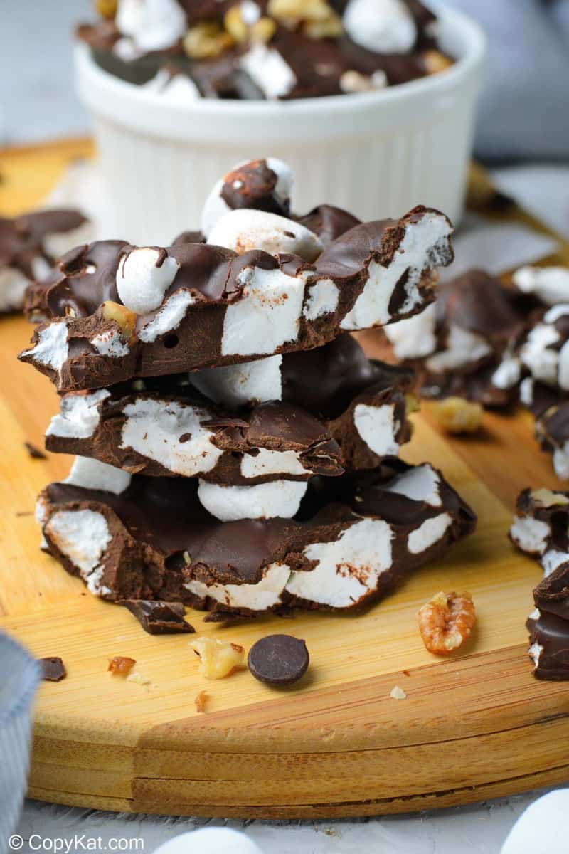 rocky road candy with walnuts stacked on a wood board