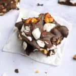 rocky road candy with walnuts stacked on parchment paper
