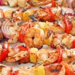 shish kabobs with steak, chicken, shrimp, and vegetables