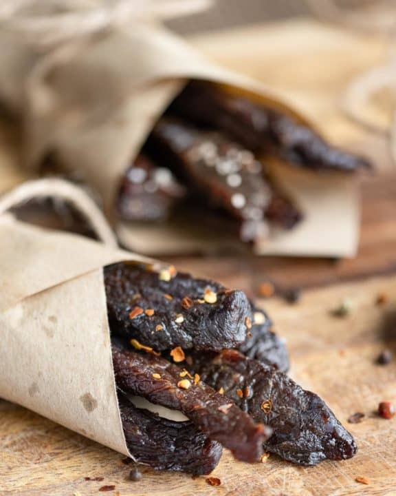 homemade spicy beef jerky wrapped in brown parchment paper