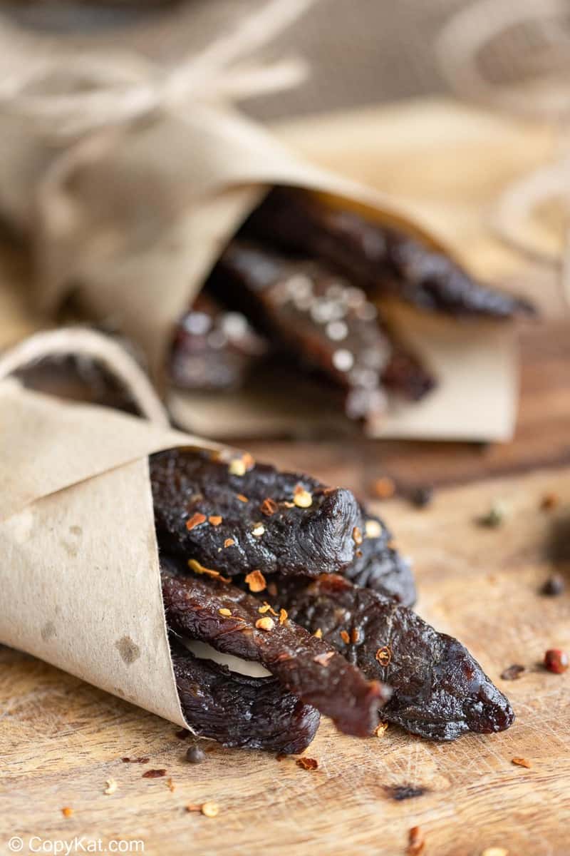homemade spicy beef jerky wrapped in brown parchment paper