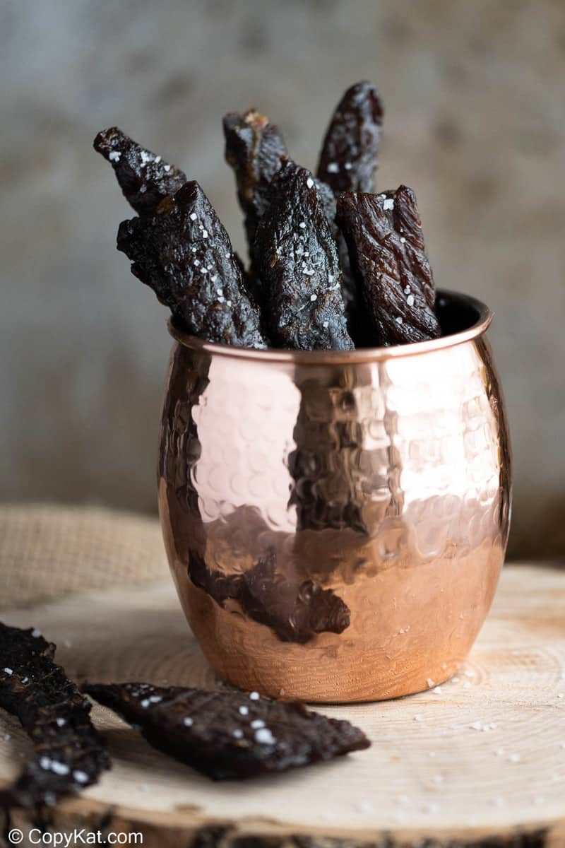 pieces of homemade teriyaki beef jerky in a cup