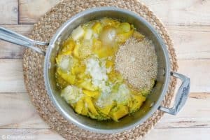 yellow squash casserole ingredient mixture in a pan