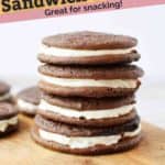Chocolate sandwich cookies stacked on a board