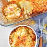 overhead view of cheesy scalloped potatoes and ham casserole in a bowl and baking dish