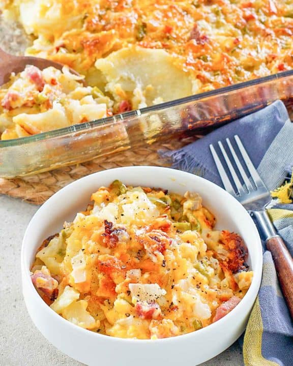 cheesy scalloped potatoes and ham casserole in a baking dish and bowl