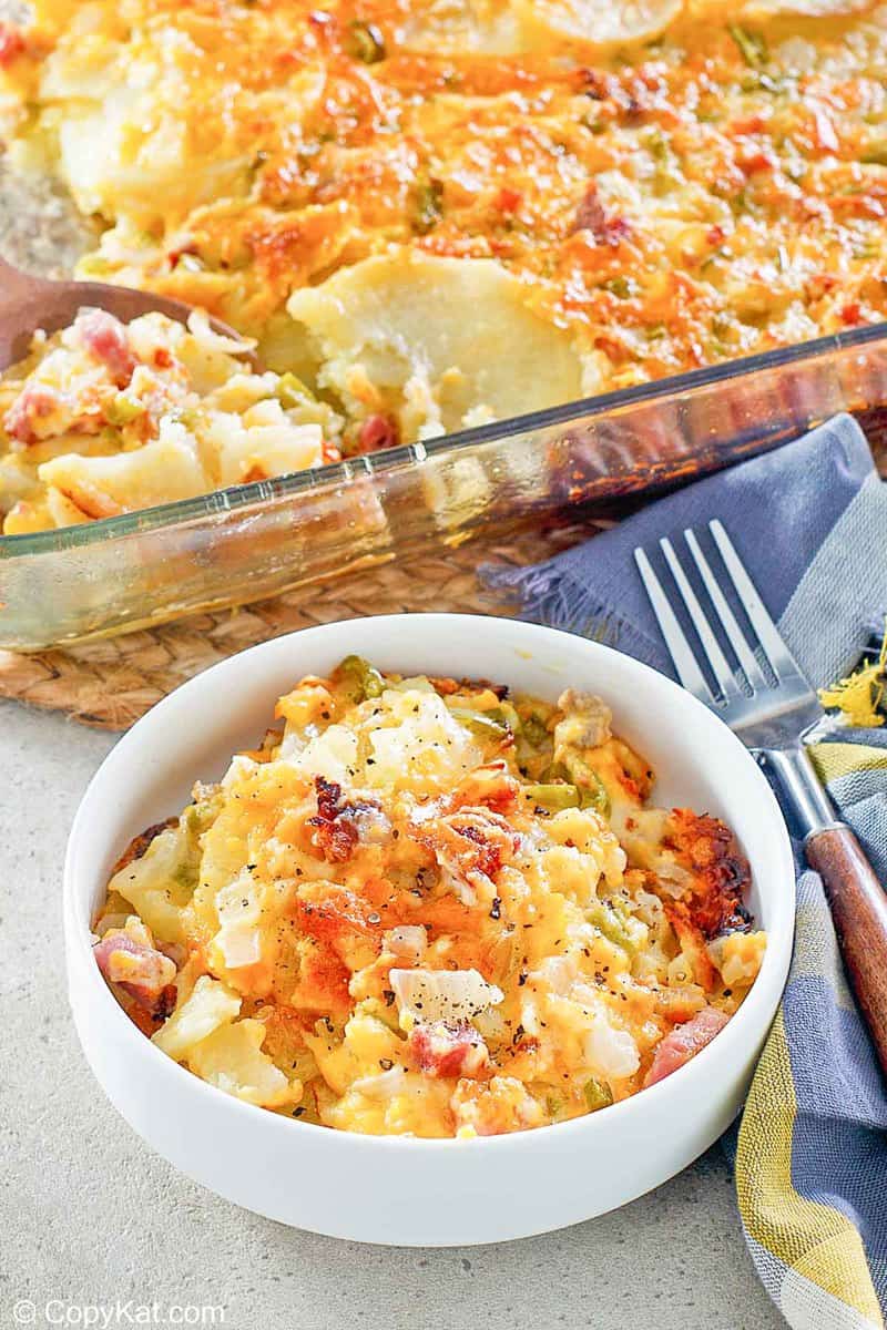 cheesy scalloped potatoes and ham casserole in a baking dish and bowl
