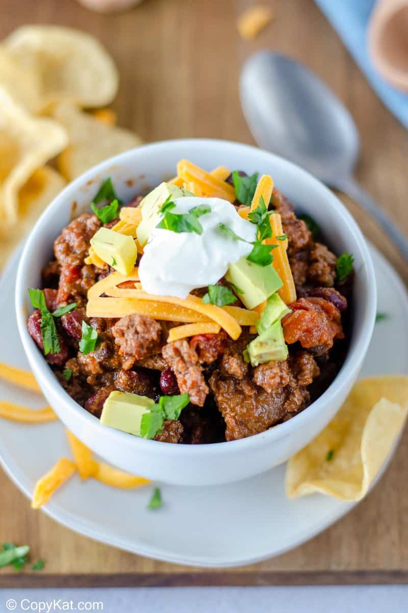 homemade chili topped with cheese, avocado, and sour cream