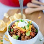 a bowl of homemade chili with a spoon in it