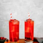 two glasses of homemade Ruby Tuesday Killer Kool Aid cocktails and cherries
