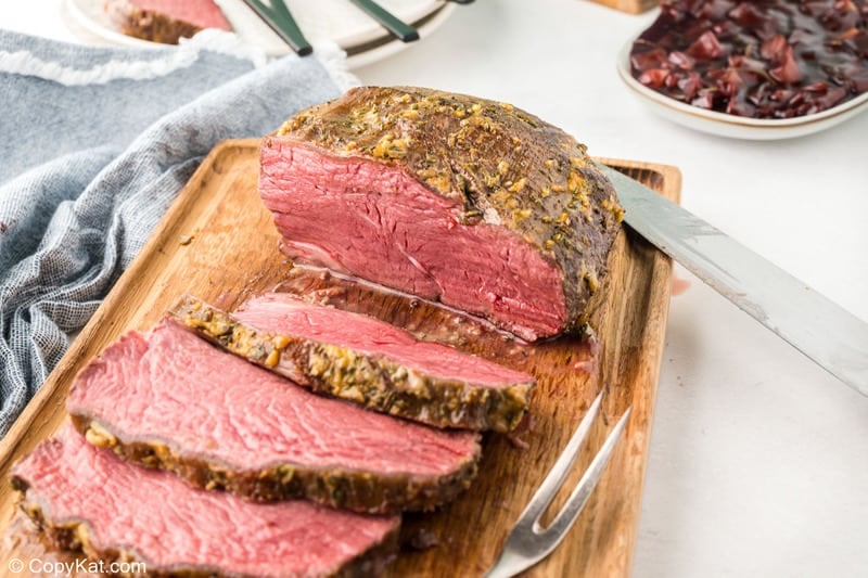 sliced New York strip roast on a cutting board