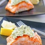 two servings of pan fried salmon with pesto cream cheese sauce