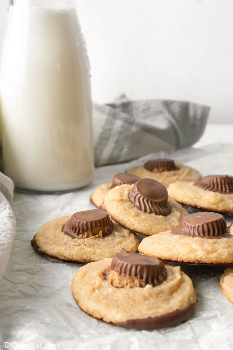 peanut butter cup cookies and milk on a table