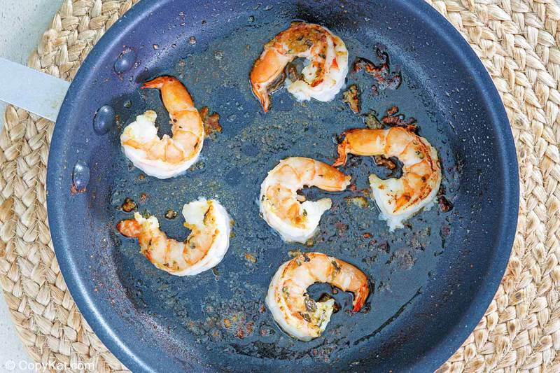 shrimp and basil garlic cheese butter sauce in a skillet